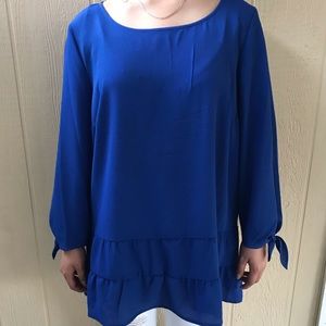Ruffle blouse in royal blue.